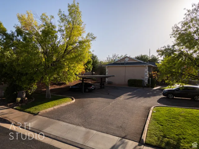 View of front of house with covered parking and stucco siding