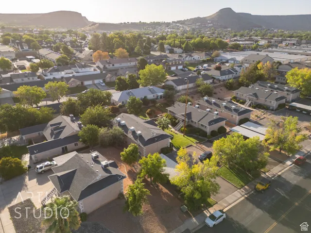 Aerial overview of property's location featuring nearby suburban area and a mountain backdrop