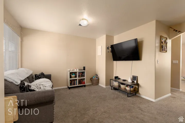 Living room with carpet floors and baseboards