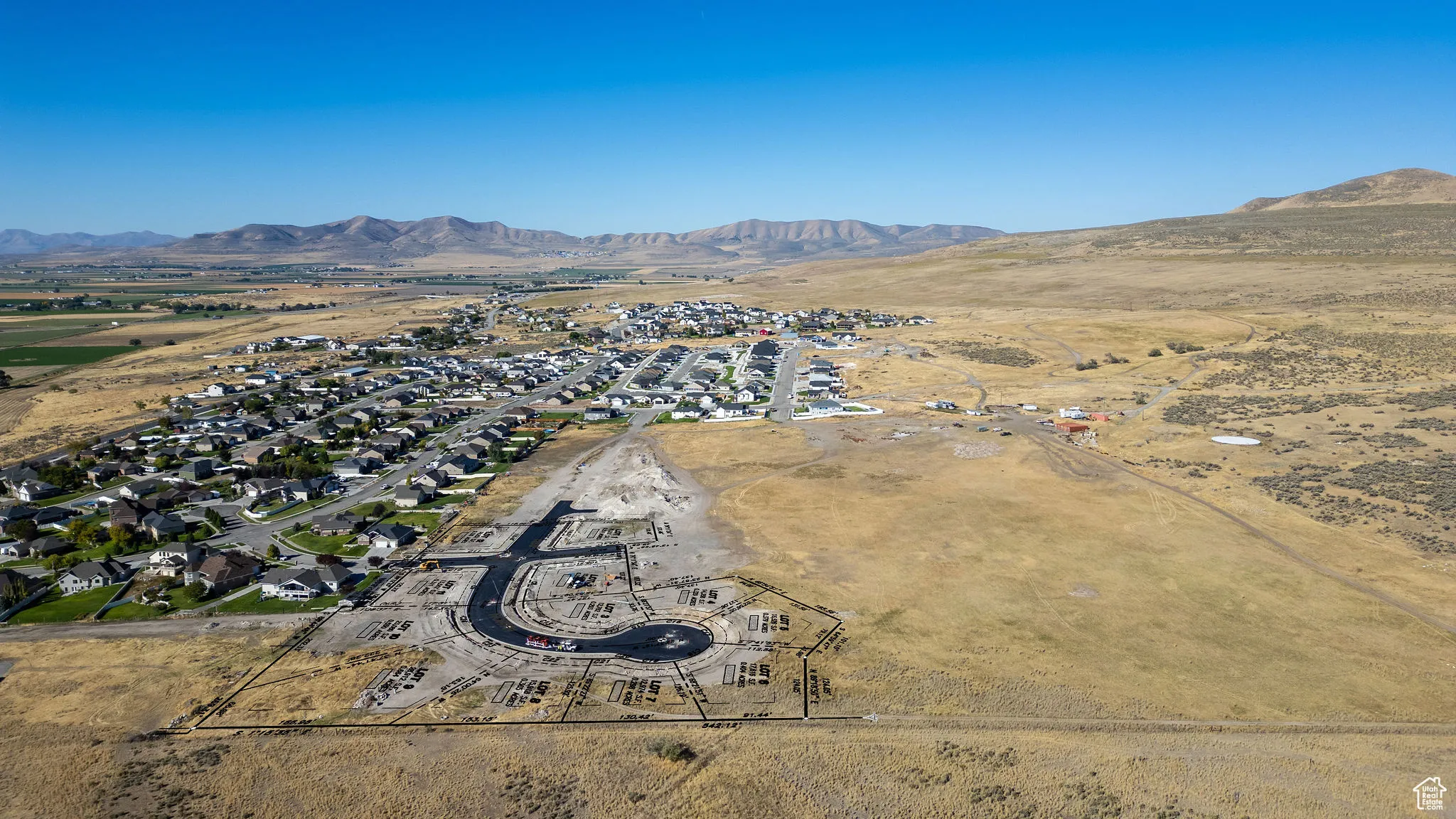 Aerial overview of property's location featuring nearby suburban area and mountains