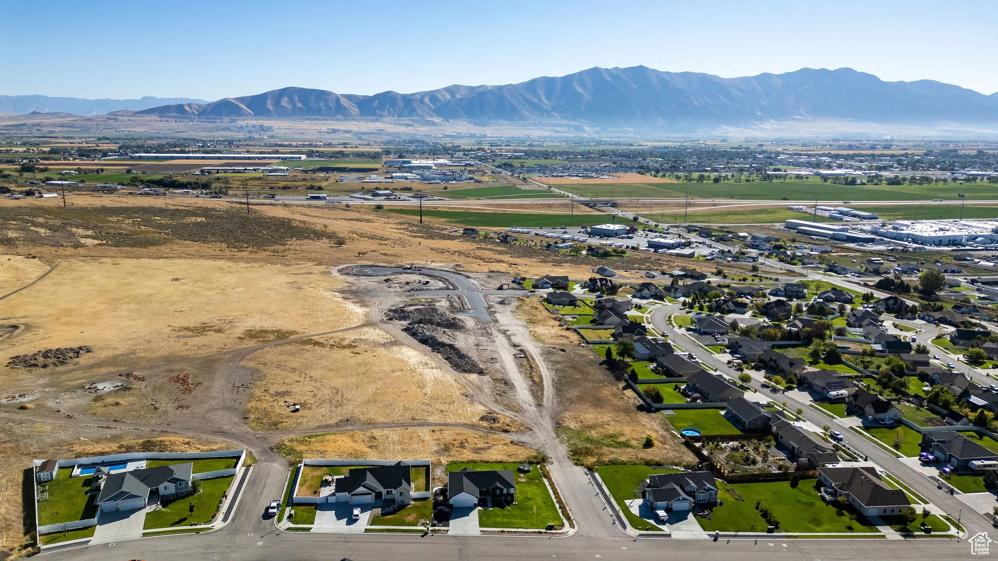 Aerial overview of property's location featuring mountains and nearby suburban area