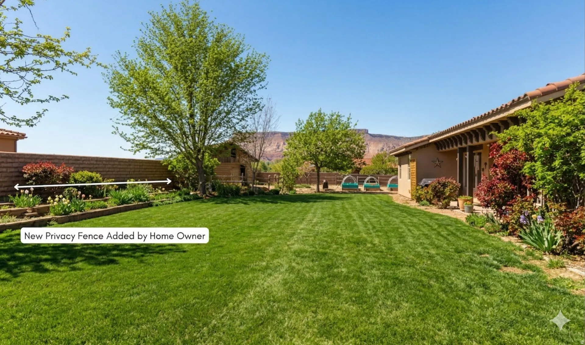 Expansive lawn with mature trees and a block wall perimeter