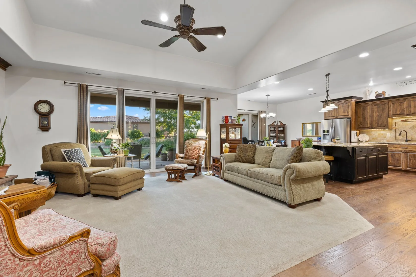 Spacious living area featuring a vaulted ceiling and recessed lighting