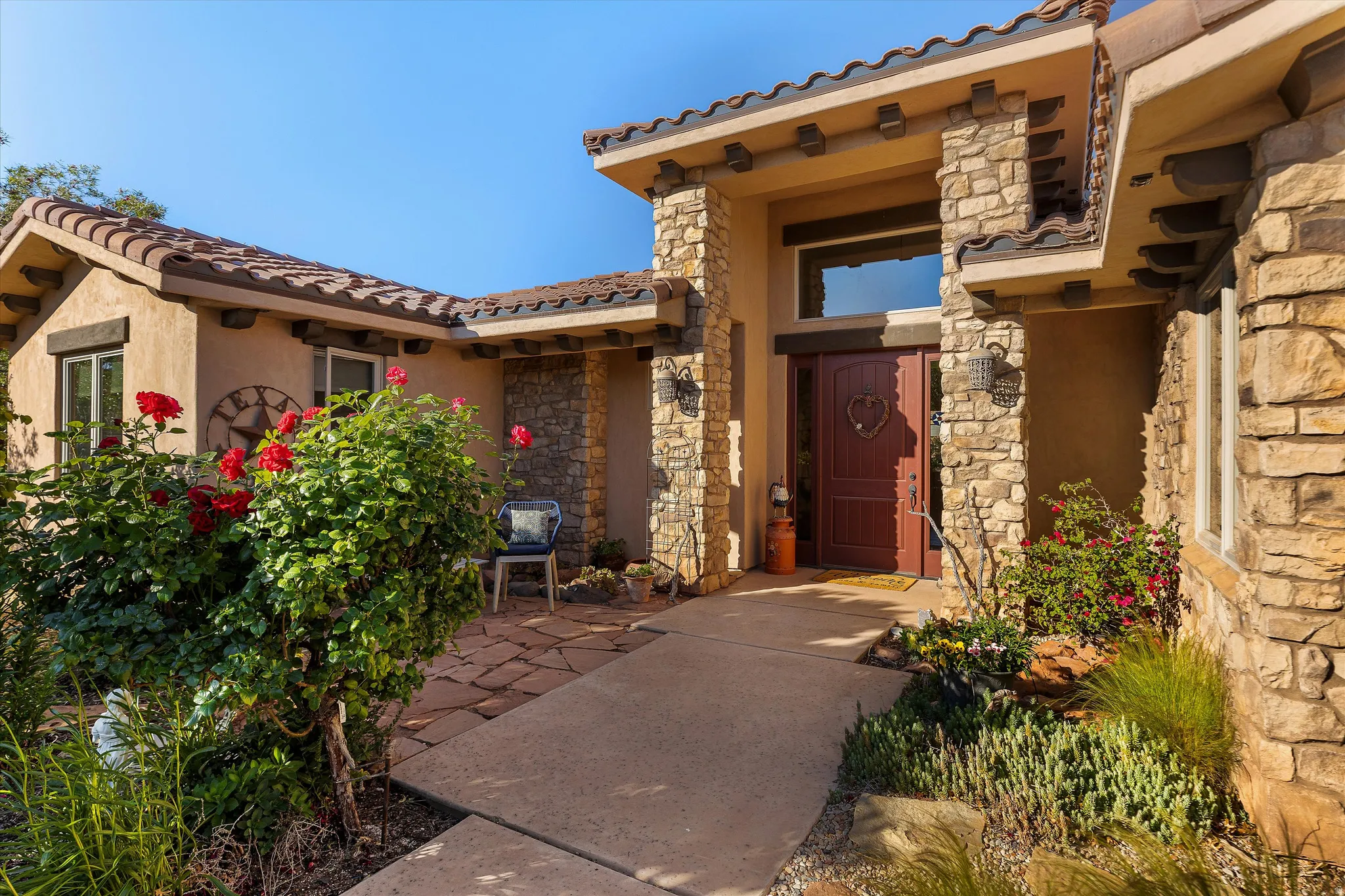 Stone and stucco exterior with a tiled roof