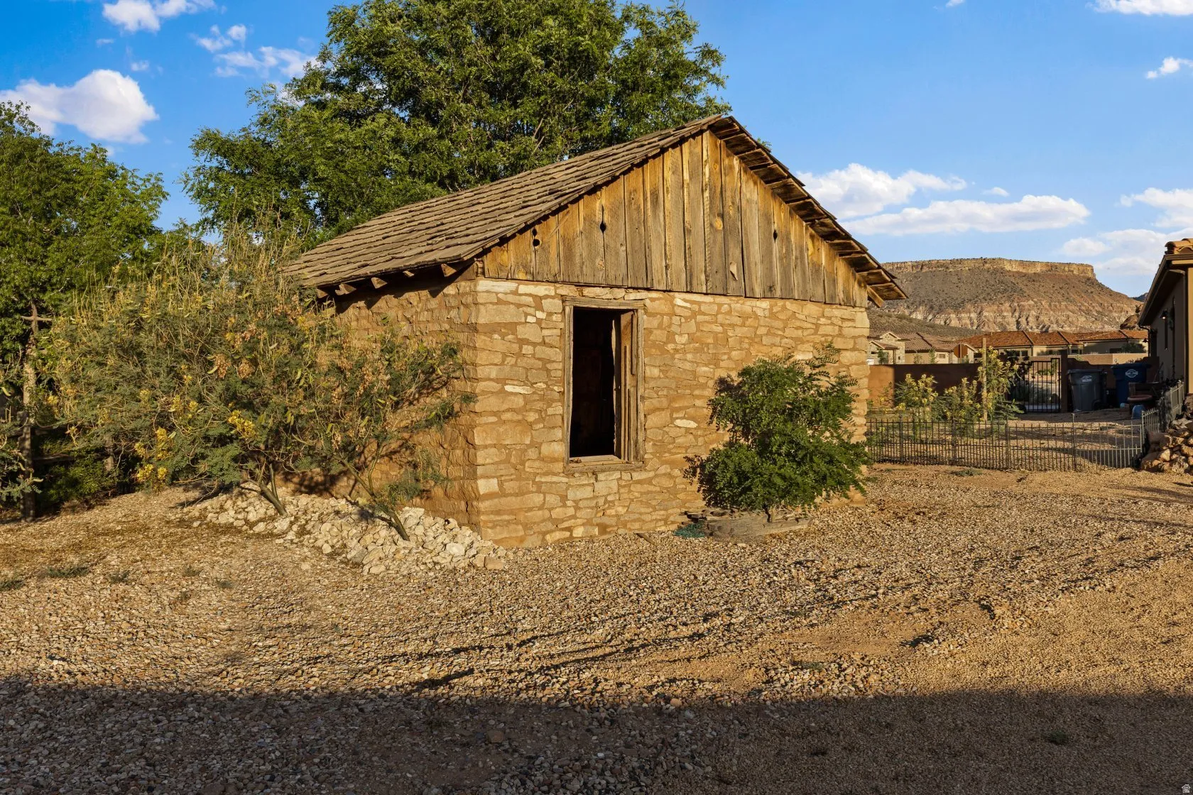Stone and wood-sided structure with a gabled roof