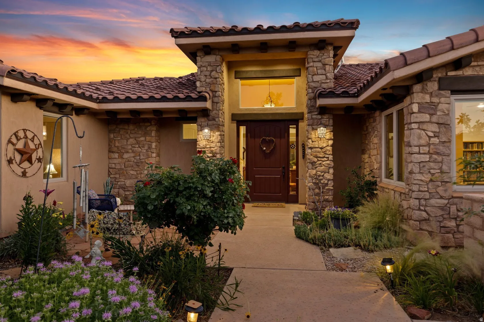 Stone veneer and stucco exterior with a tile roof