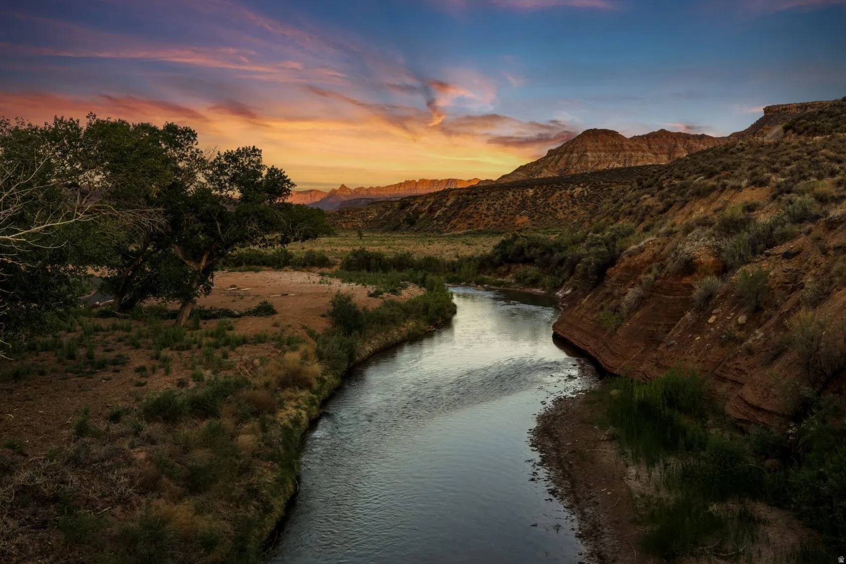 River winding through a canyon landscape with mountainous terrain