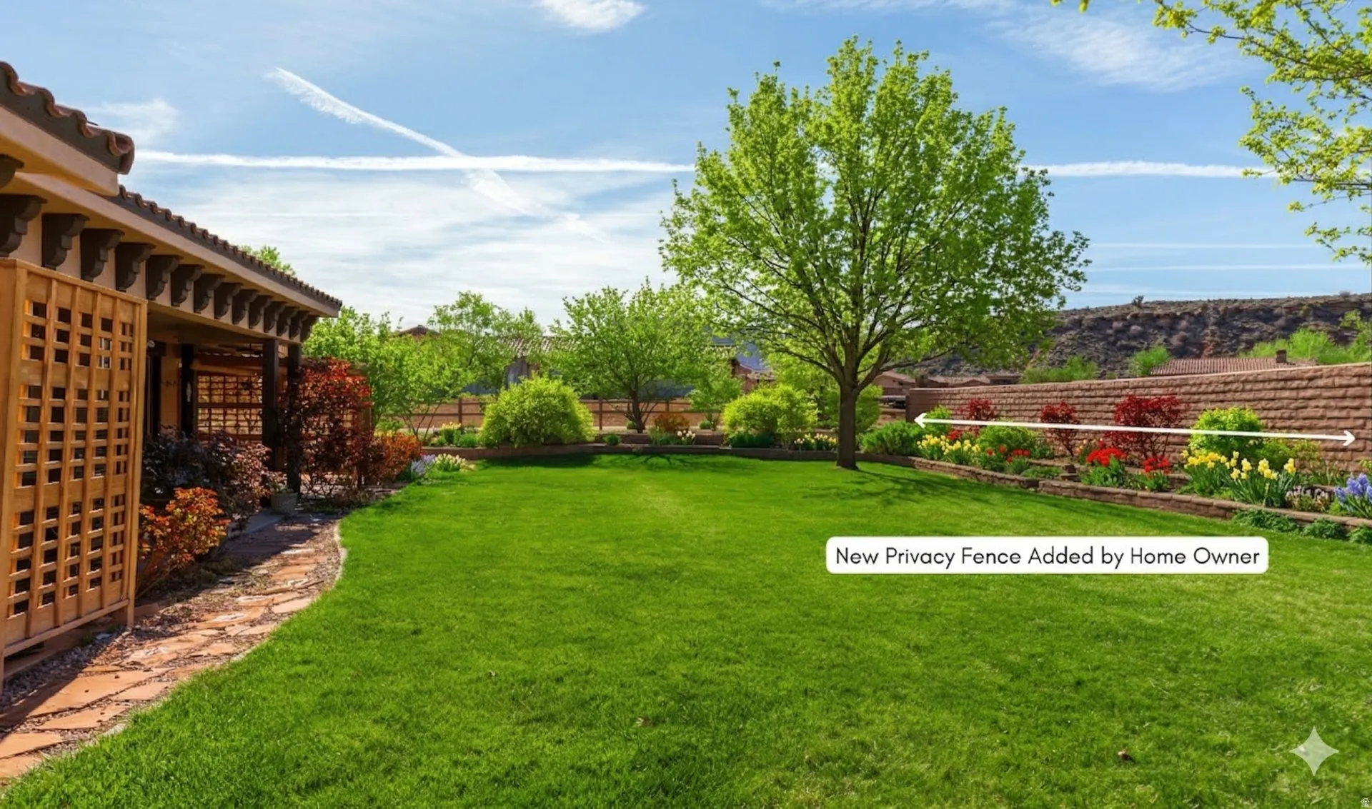 Expansive backyard featuring a manicured lawn, established landscaping, and a brick privacy fence