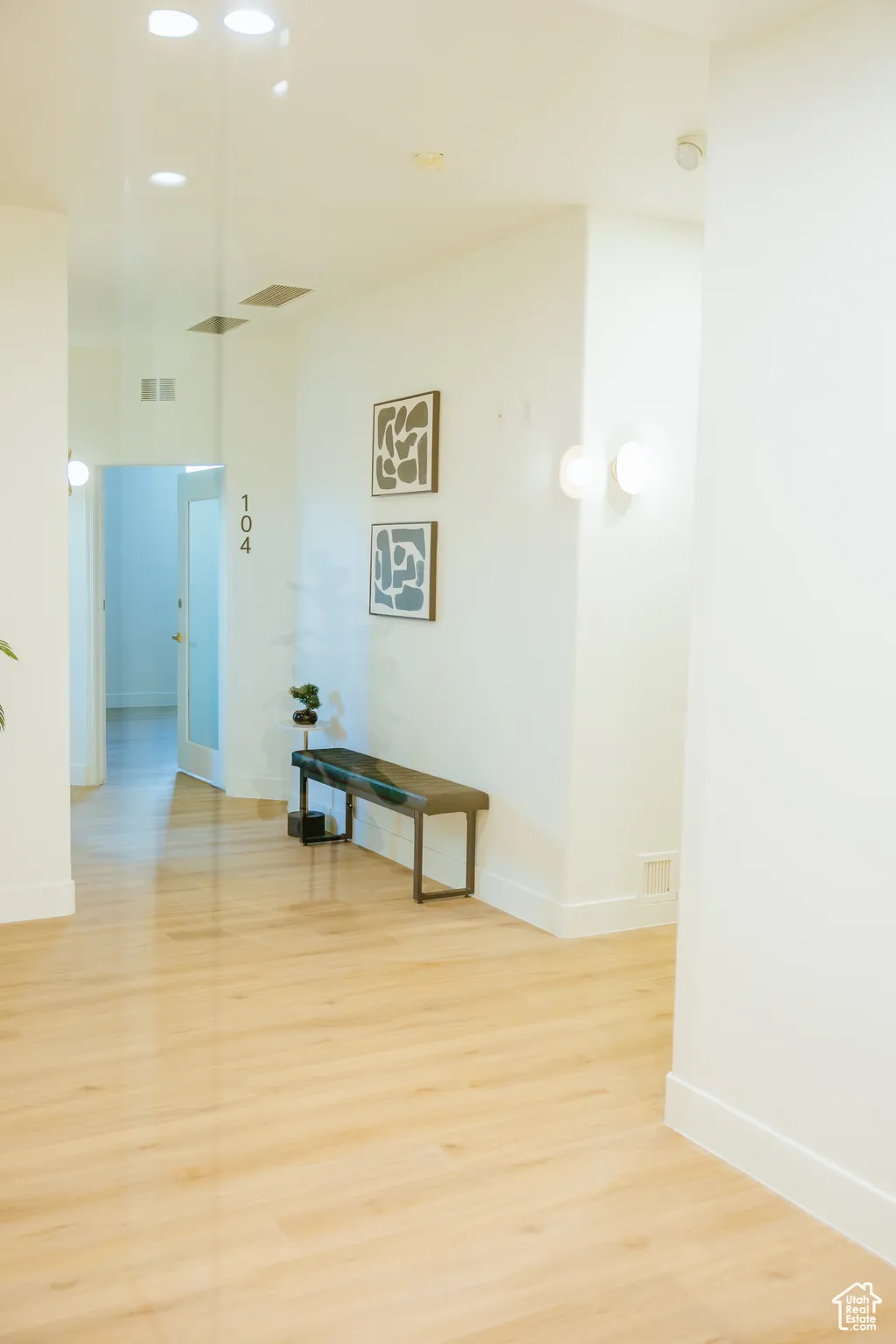 Corridor featuring light wood-style floors and baseboards
