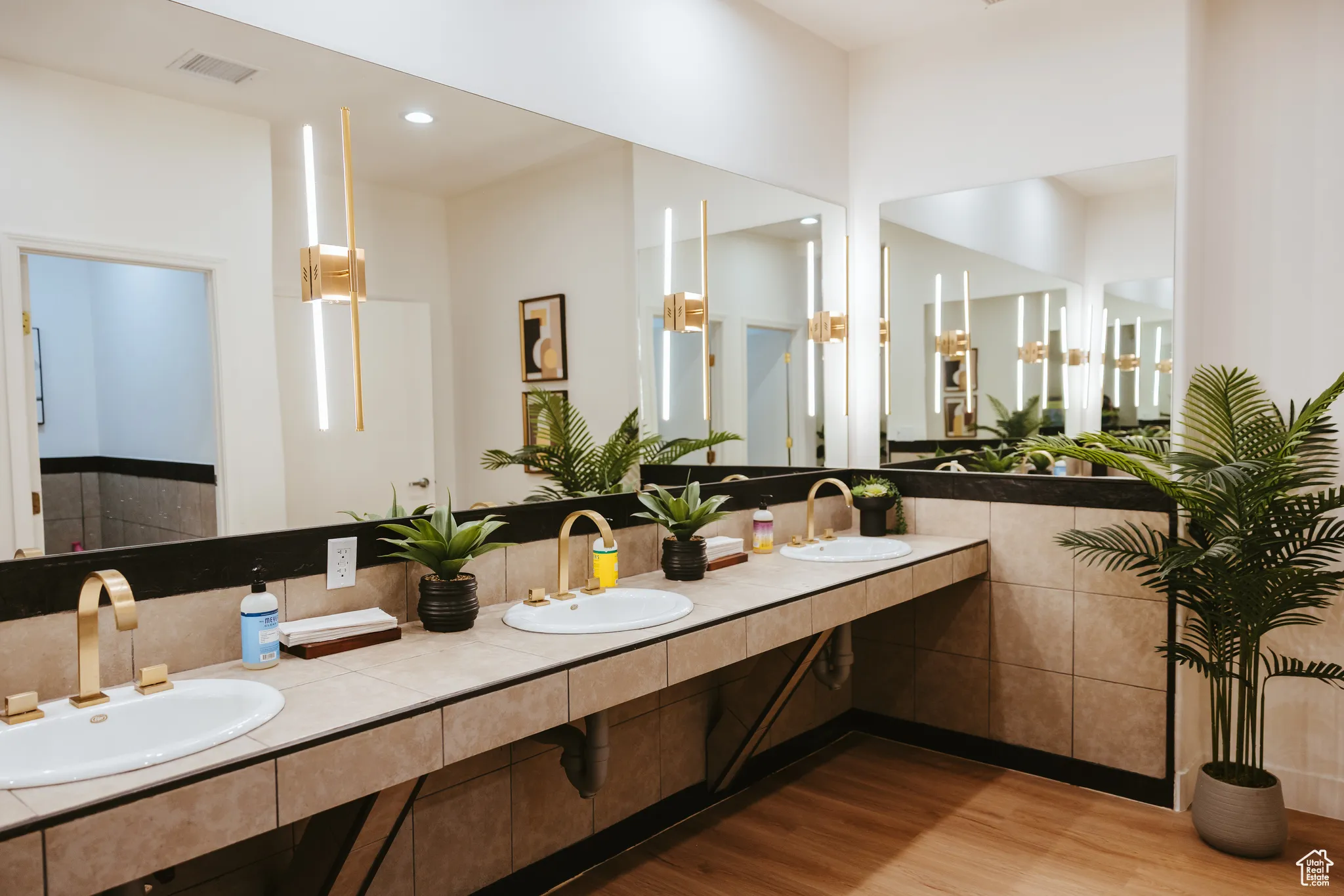 Full bath featuring wood finished floors and double vanity
