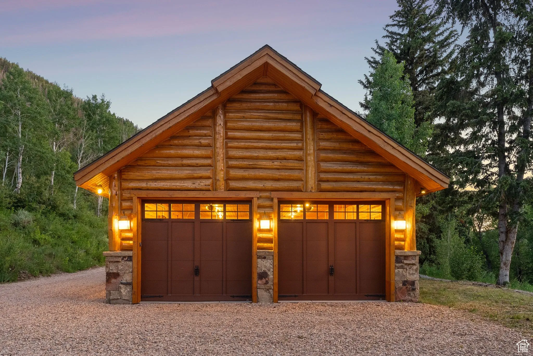 Garage at dusk featuring a detached garage