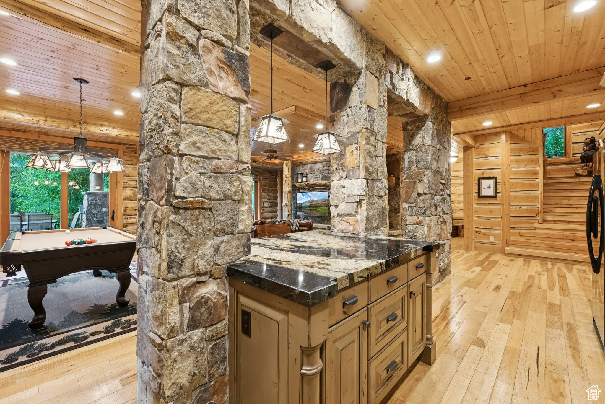 Kitchen with light wood floors, a tongue-in-groove ceiling with exposed beams, recessed lighting, pool table, and decorative light fixtures