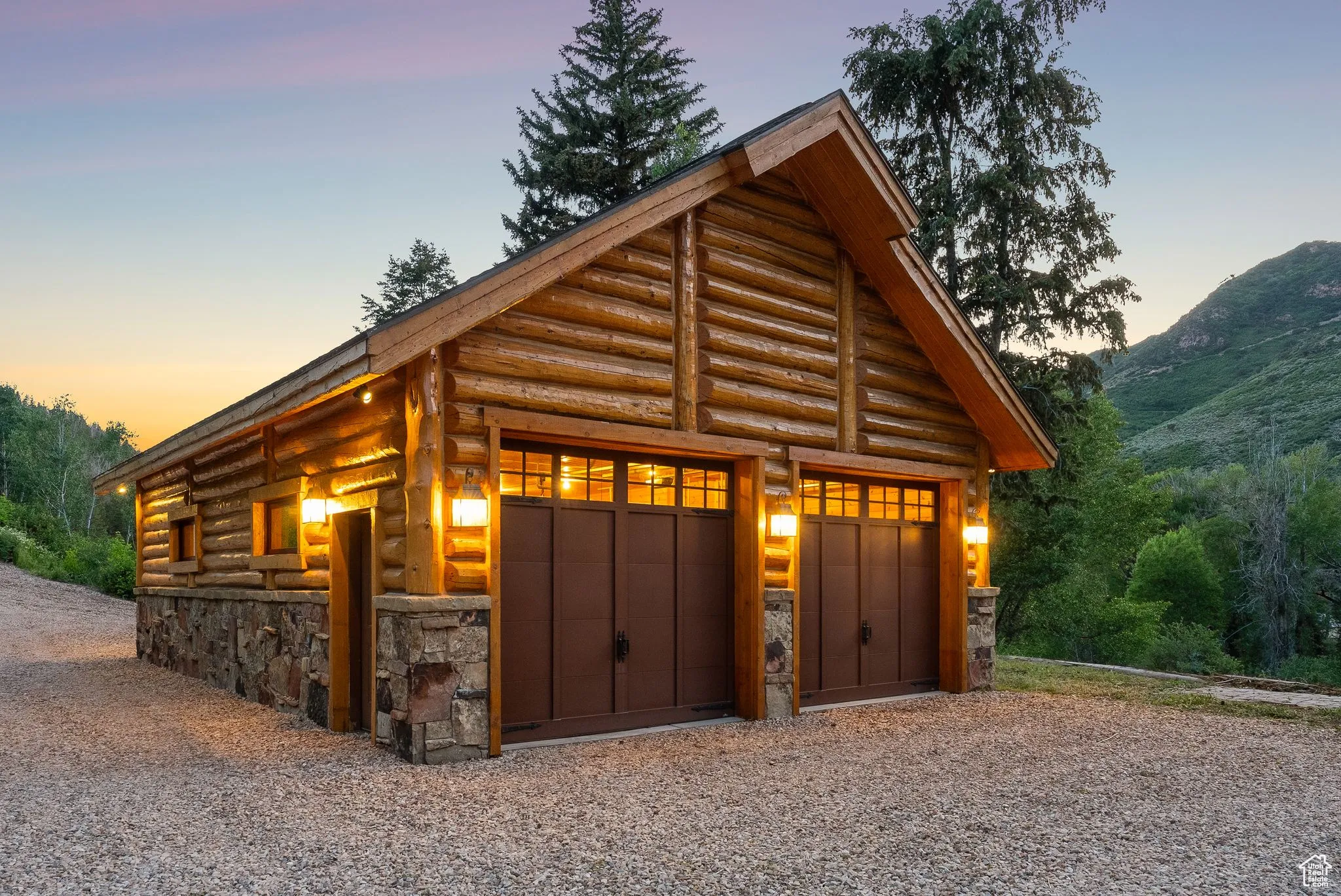 Garage at dusk featuring a garage and a mountain view