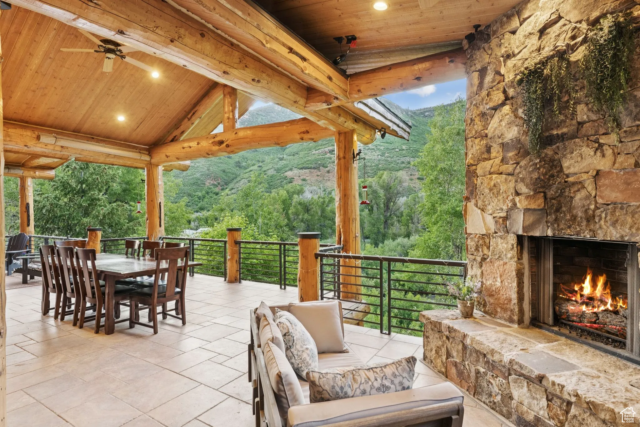 View of patio with outdoor dining space and an outdoor living space with a propane fireplace