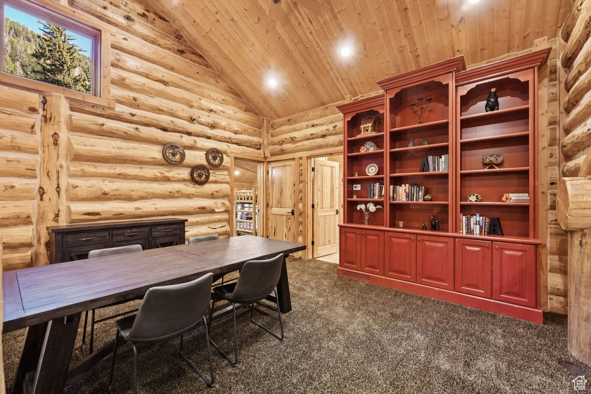 Home office featuring tongue-in-groove ceiling, high vaulted ceiling, dark colored carpet, rustic walls, and recessed lighting