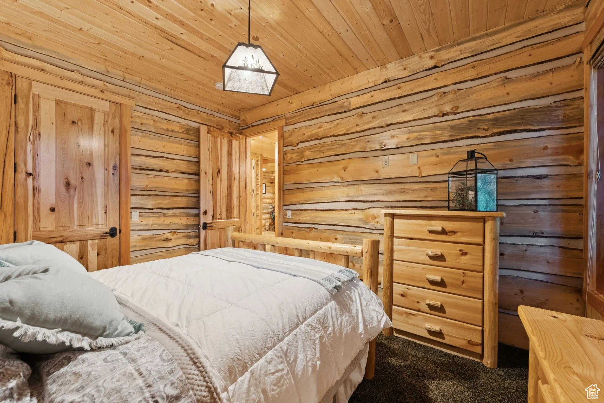 Bedroom featuring dark colored carpet and tongue-in-groove ceiling