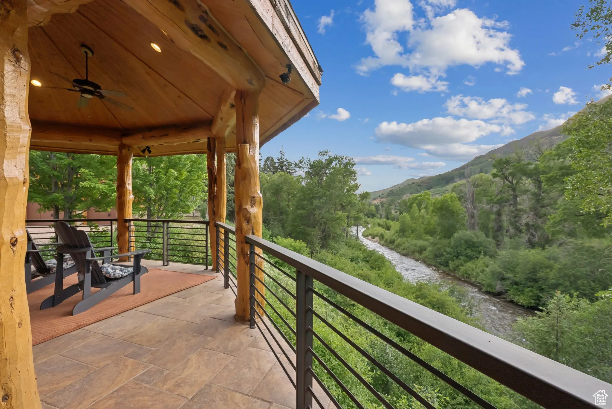 Balcony featuring a serene mountain view and ceiling fan.