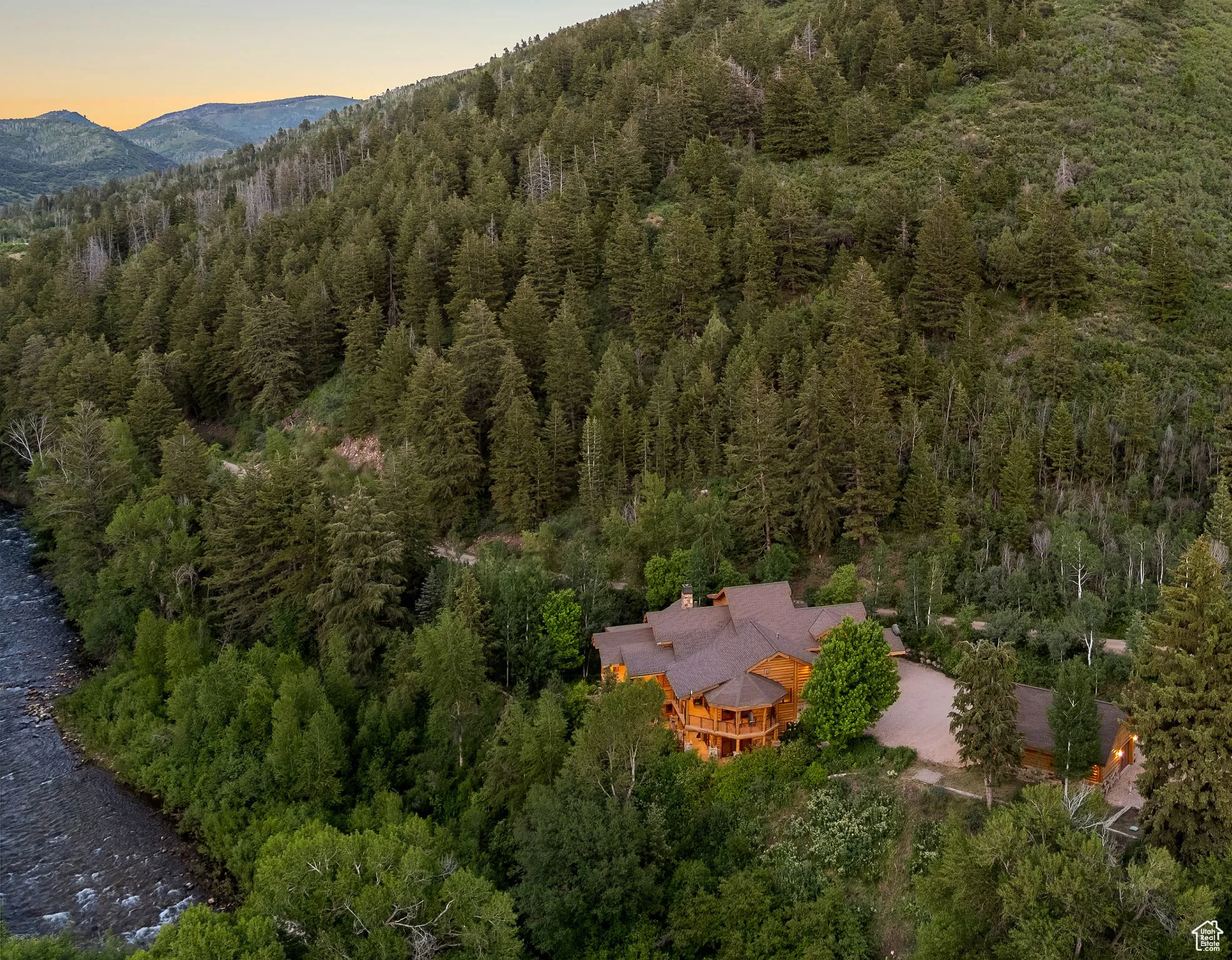 Aerial view at dusk of a view of trees and a mountain view