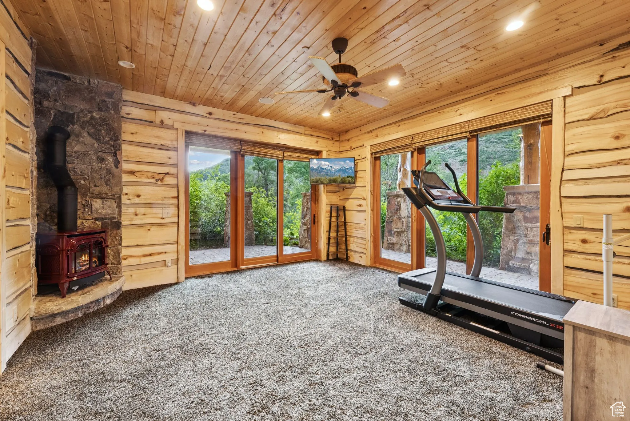 Exercise/bedroom featuring a tongue-in-groove ceiling, carpet, recessed lighting, a propane stove, and a ceiling fan