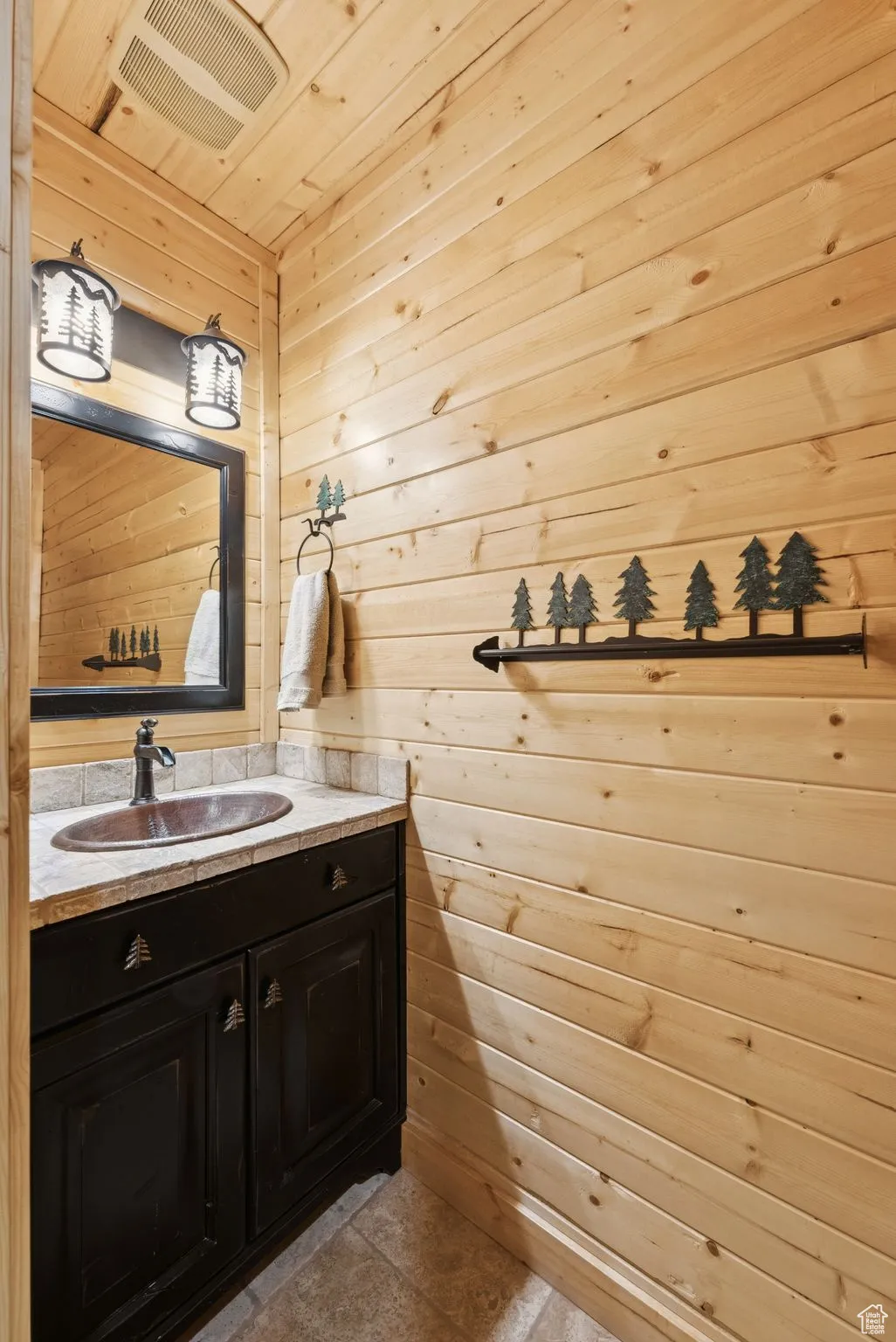 Bathroom featuring wooden walls, vanity, and wood ceiling