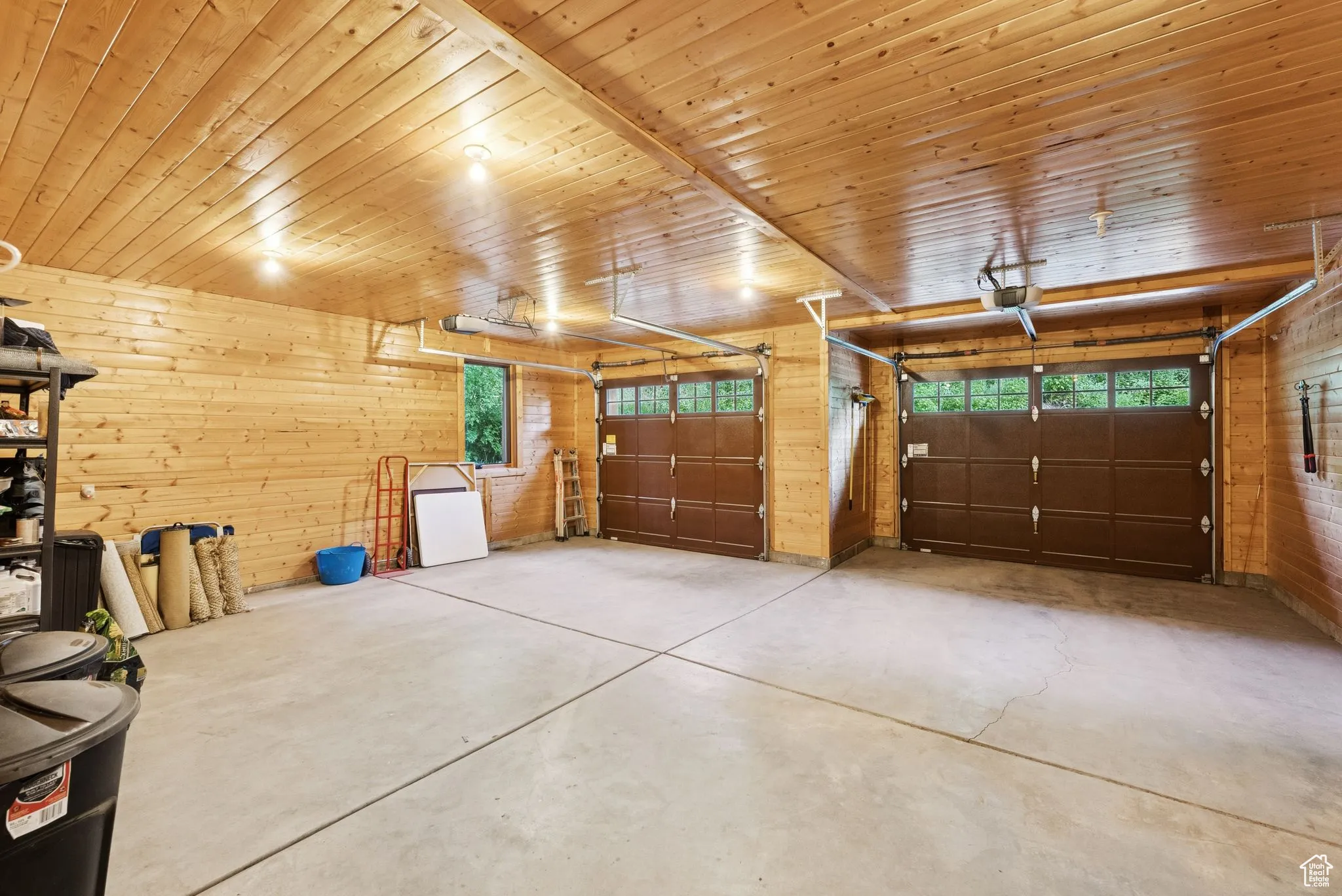 Garage with lounge-in-groove walls and a garage door opener