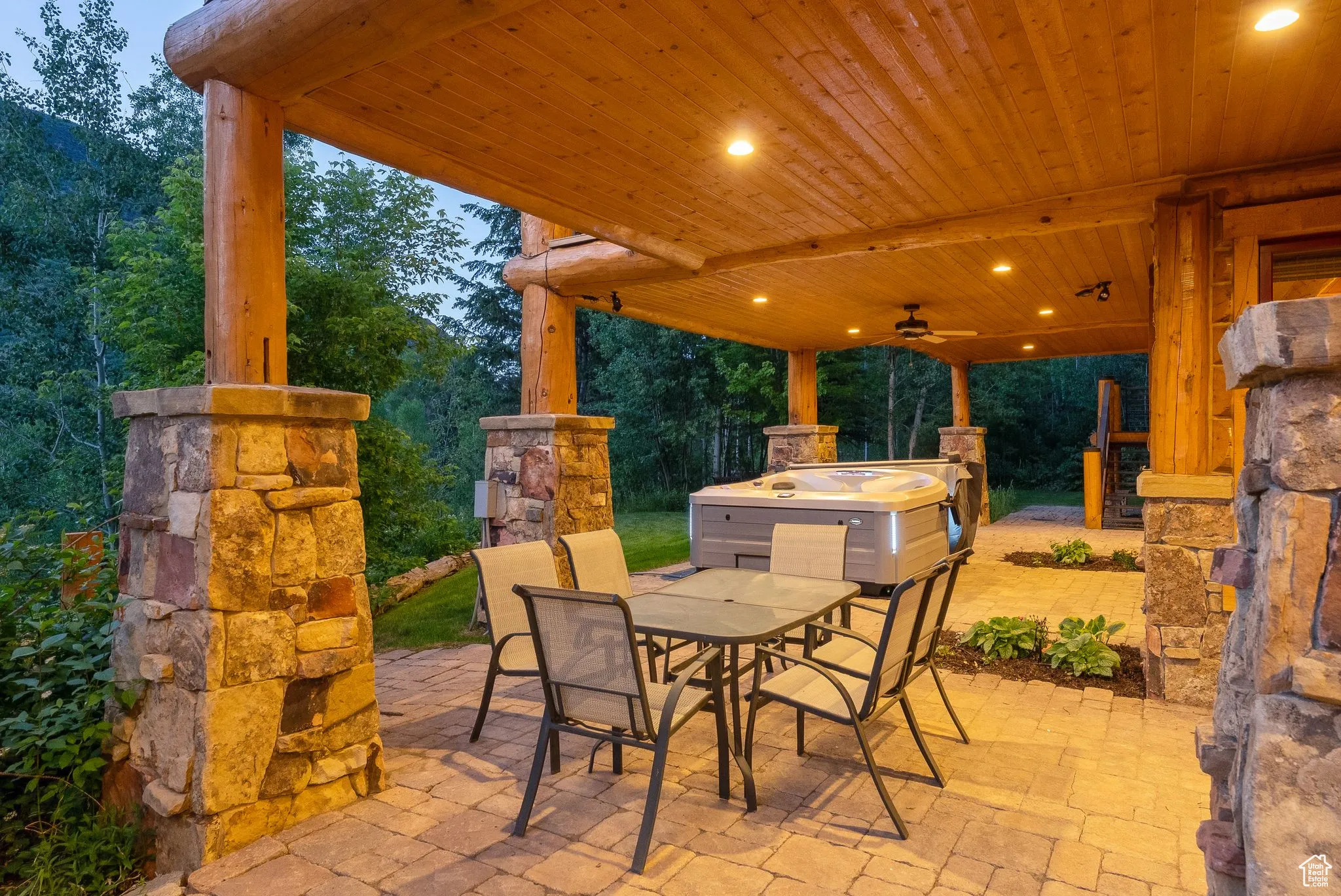 View of patio with outdoor dining space and ceiling fan