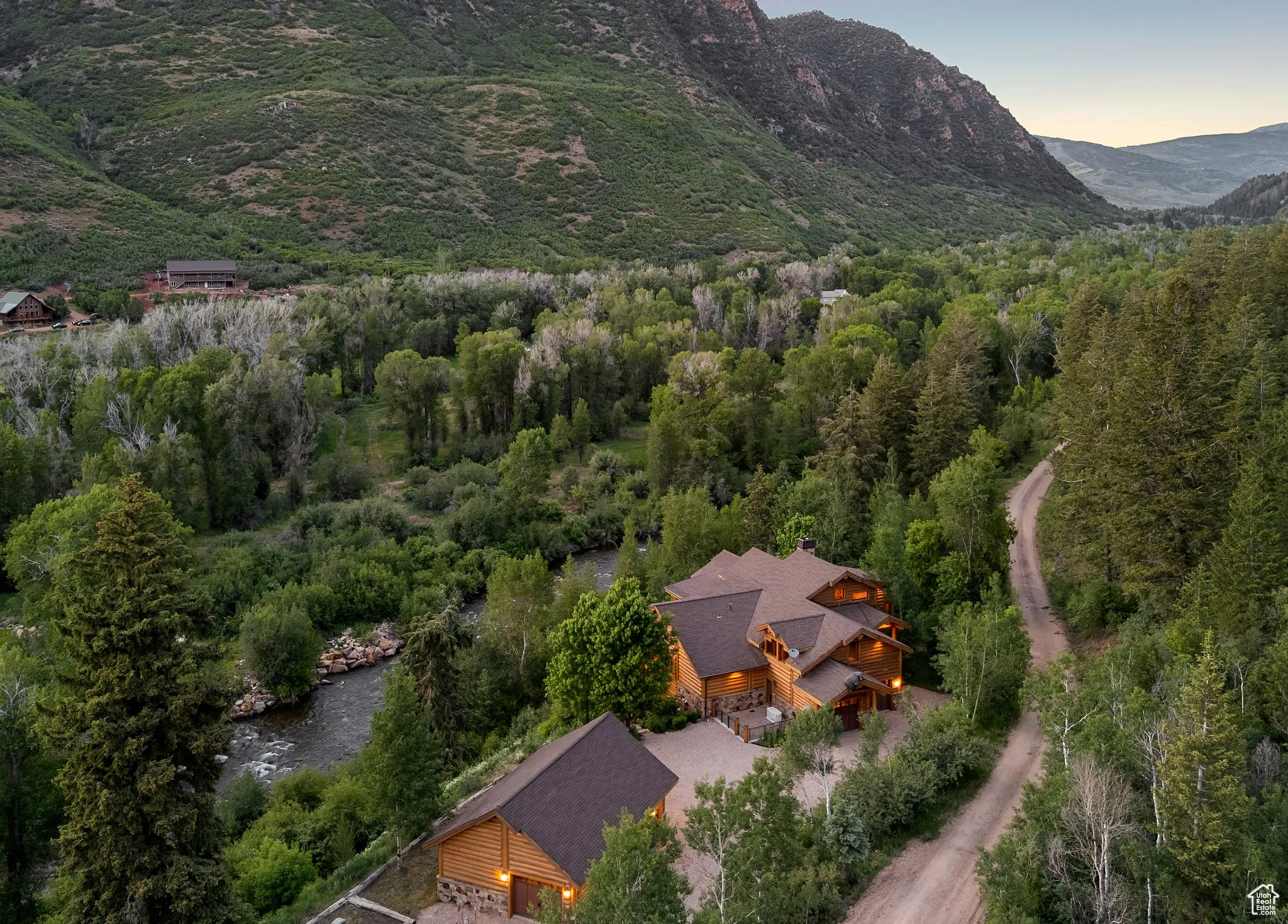 Aerial view at dusk of a view of trees and a mountain view