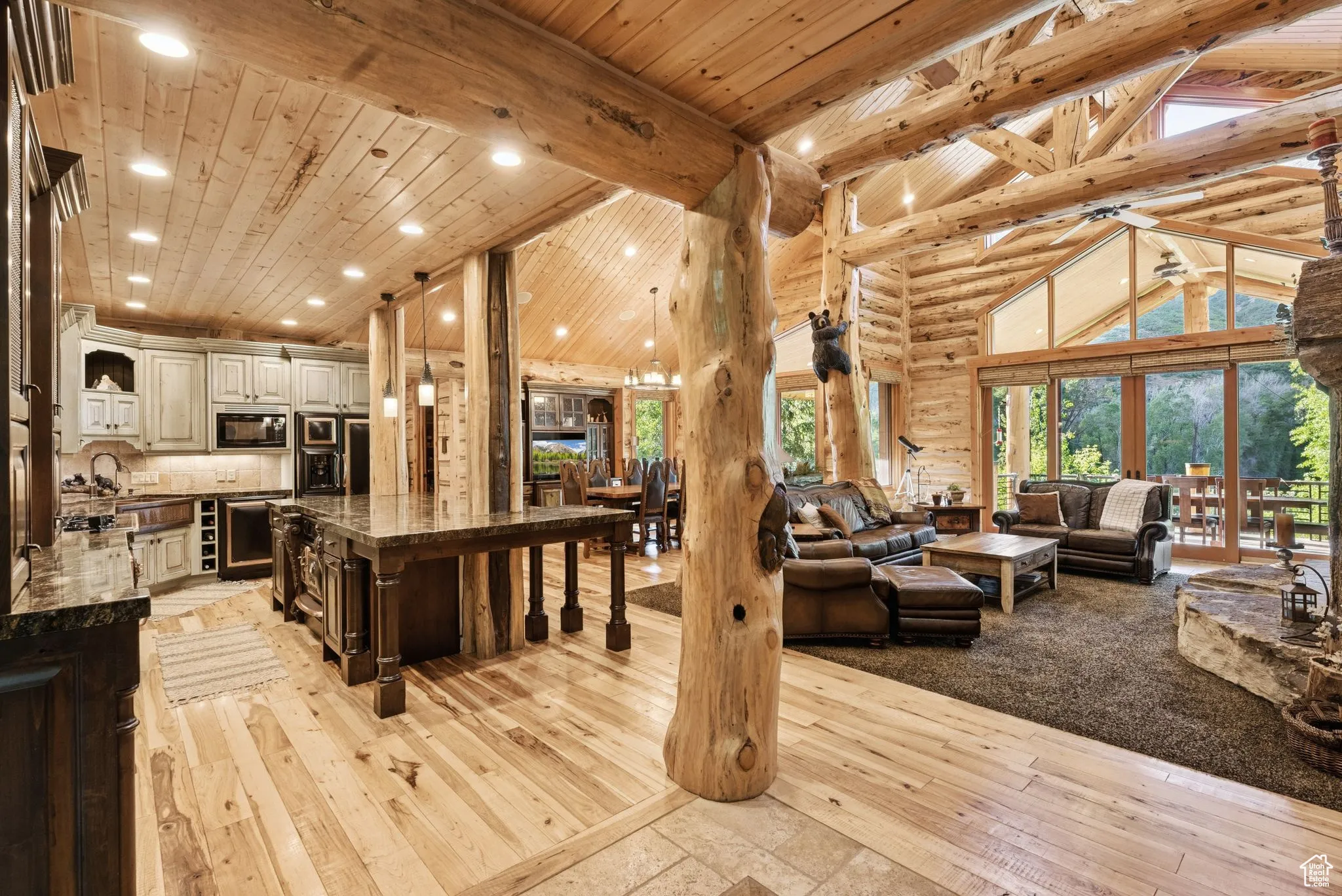 Living room with high vaulted ceiling, light wood finished floors, recessed lighting, a tongue-in-groove ceiling with exposed beams