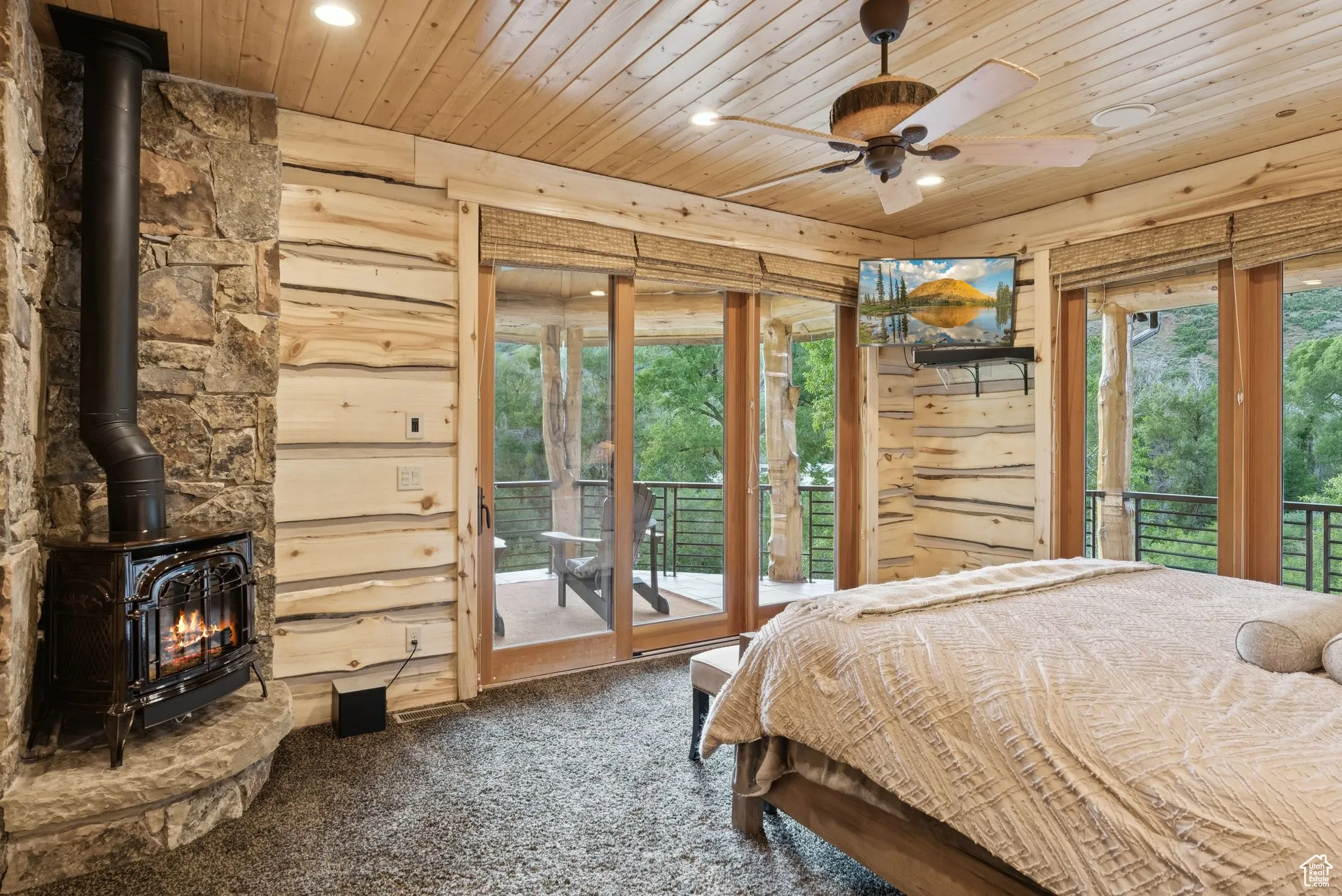 Carpeted bedroom featuring a propane stove, tongue-in-groove ceiling, recessed lighting, and access to exterior