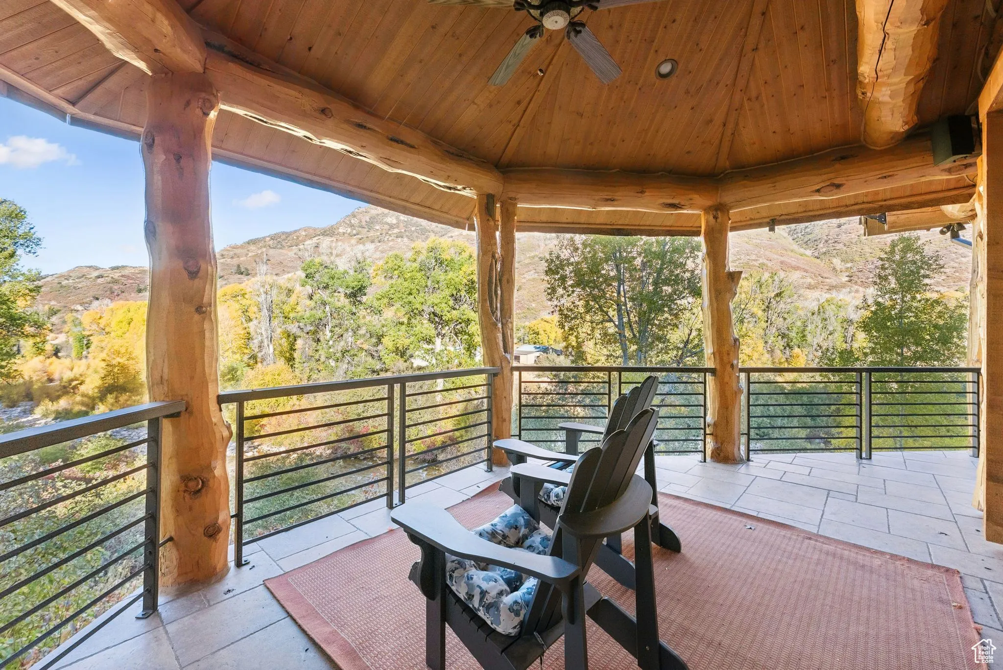 View of patio / terrace with a ceiling fan and a mountain view