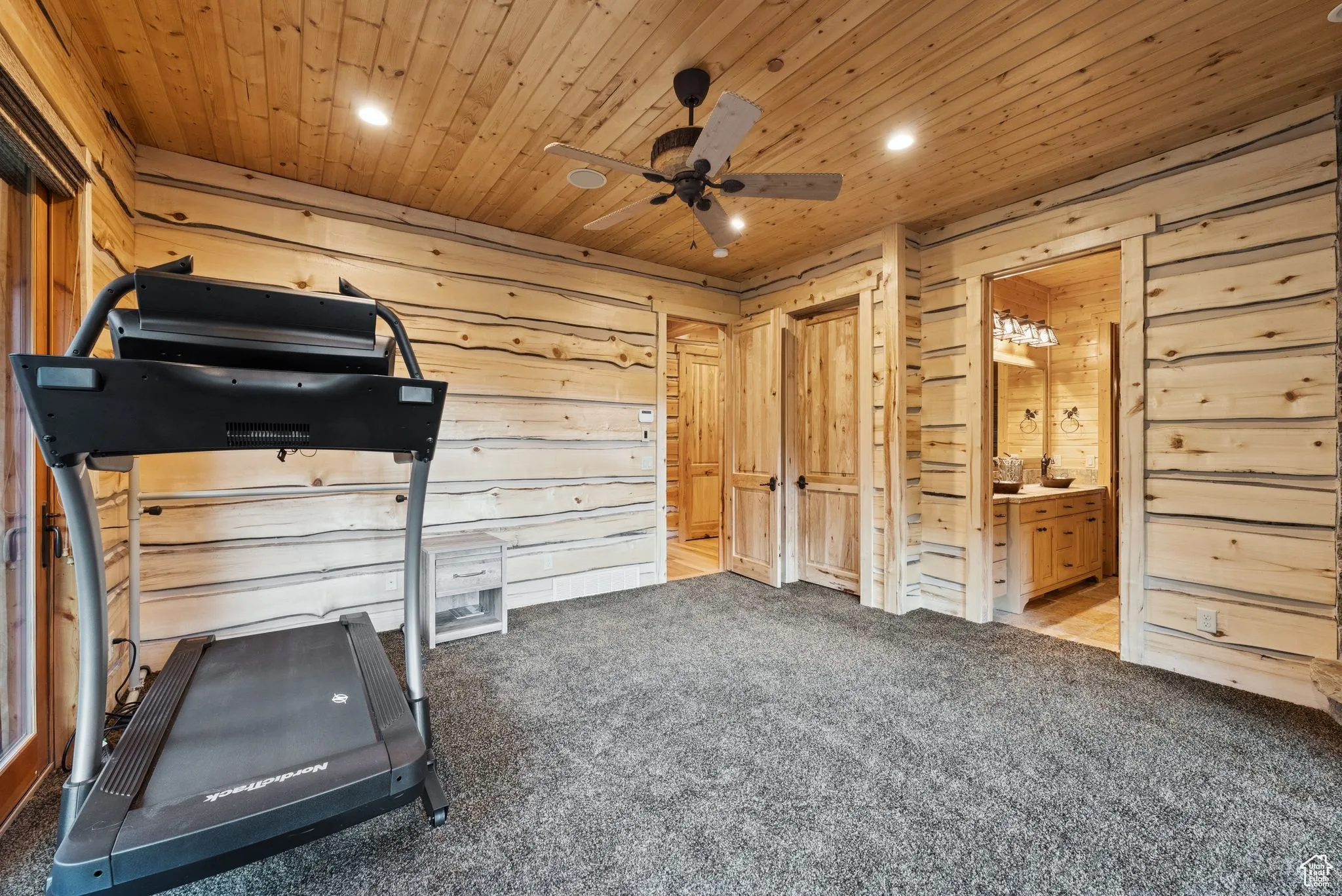 Exercise/bedroom with ceiling fan, wooden walls, carpet, recessed lighting, and tongue-in-groove ceiling