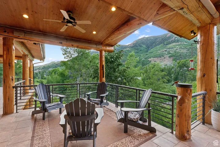 View of patio featuring a mountain view and ceiling fan