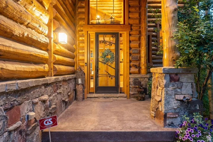 Doorway to property with stone siding