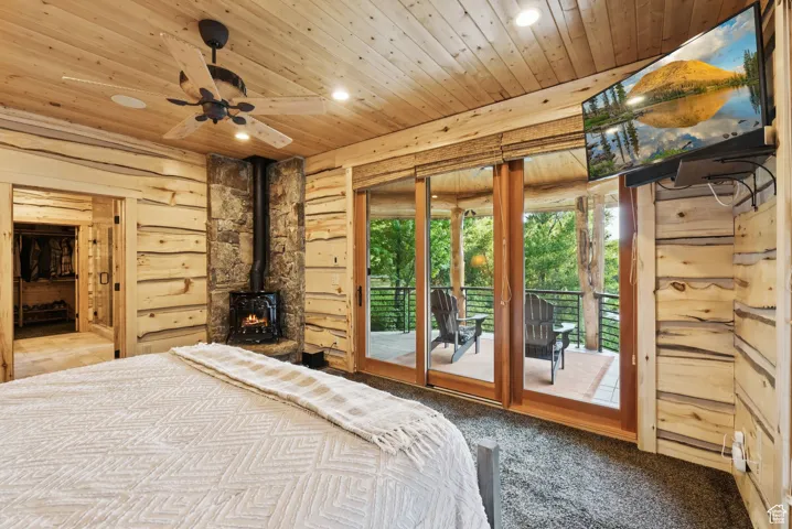 Carpeted bedroom with tongue-in-groove ceiling, recessed lighting, access to outside, and a propane stove