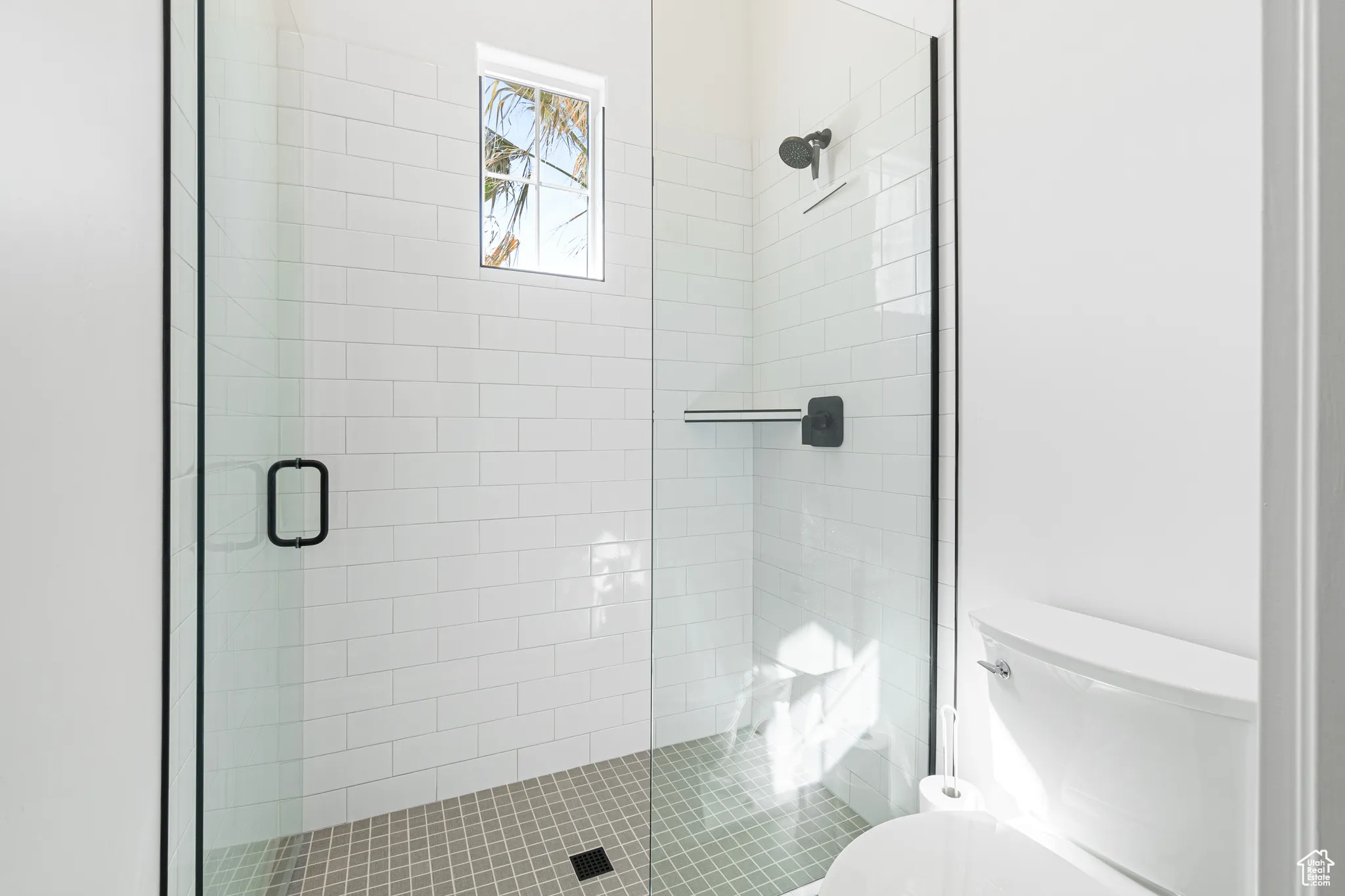 Full bath featuring toilet and a shower stall