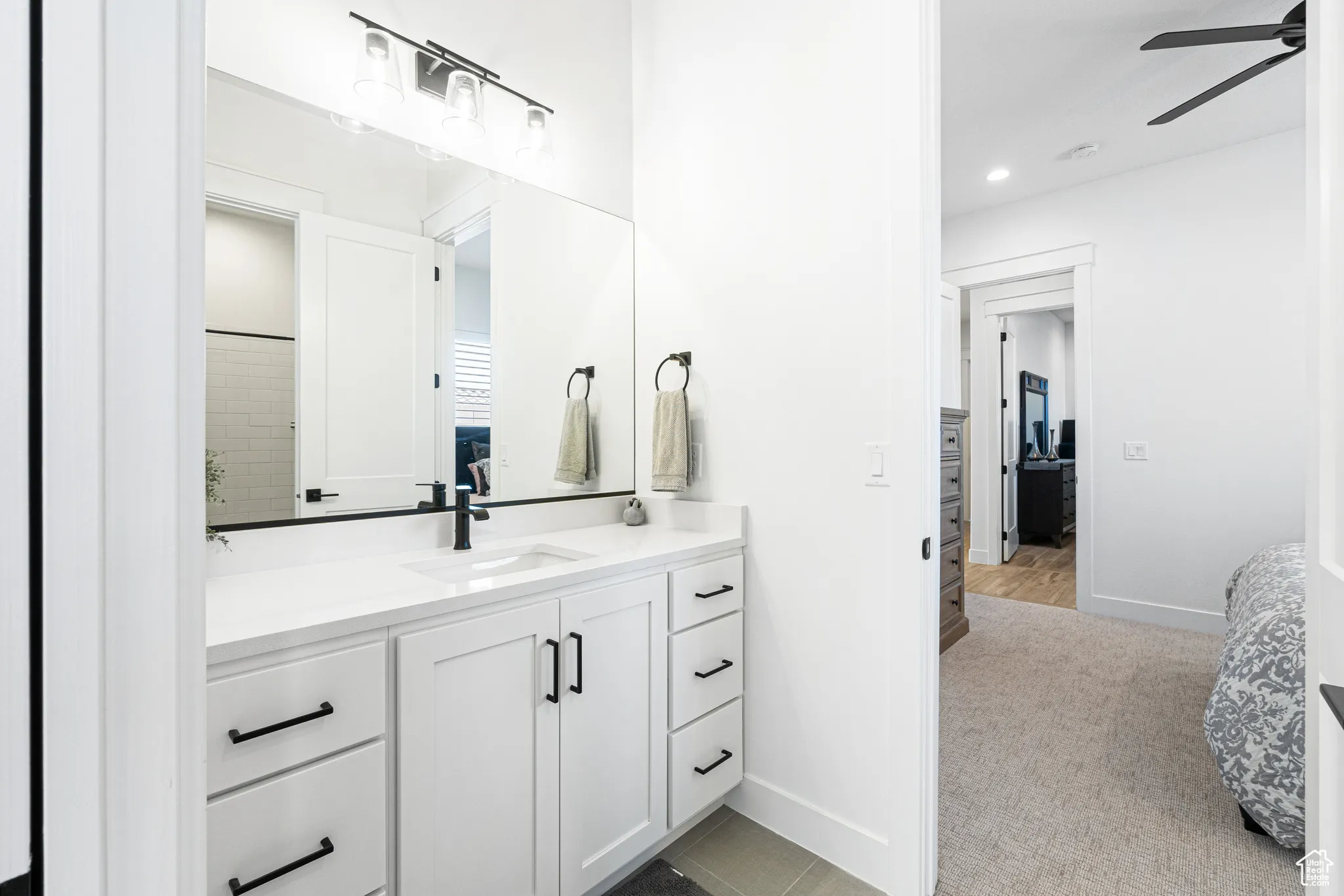 Ensuite bathroom with ceiling fan, vanity, and recessed lighting