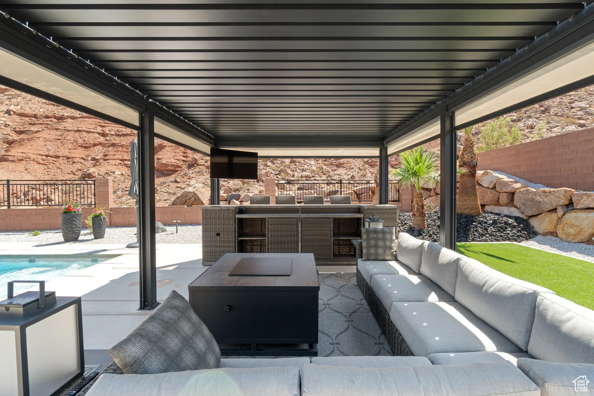 Fenced backyard with an outdoor hangout area and a patio