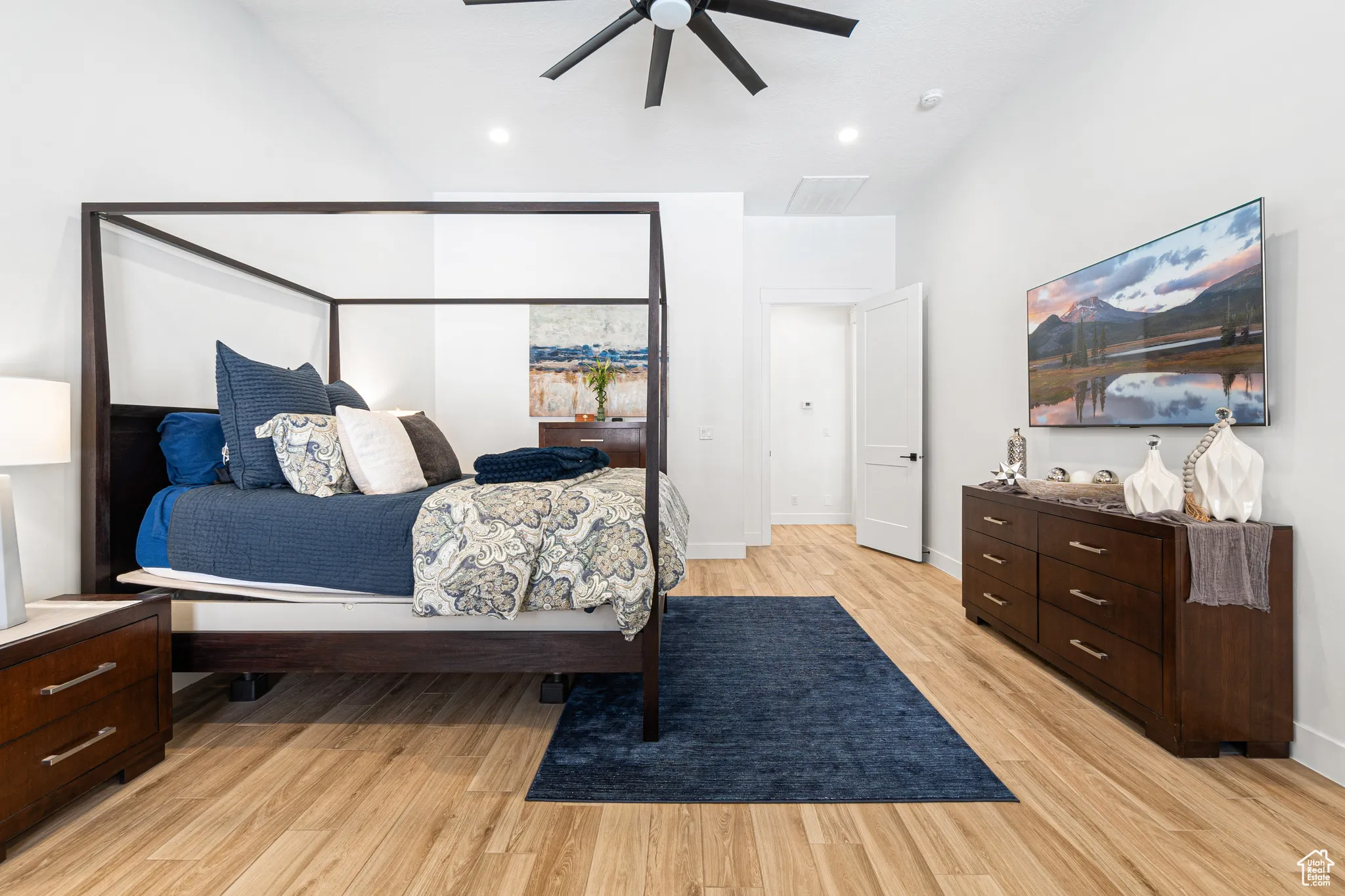 Bedroom featuring light wood-type flooring, vaulted ceiling, a ceiling fan, and recessed lighting