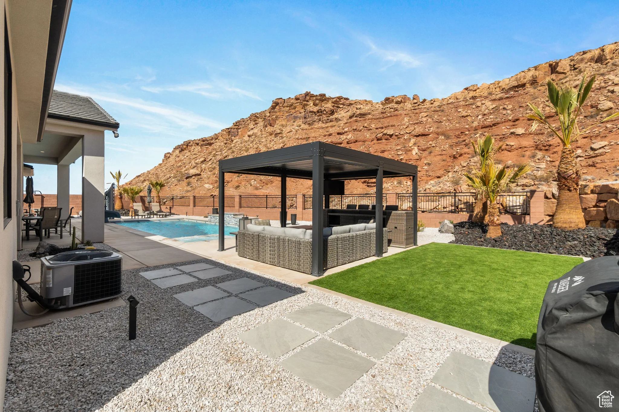 Fenced backyard featuring an outdoor hangout area, a mountain view, a patio, a gazebo, and area for grilling
