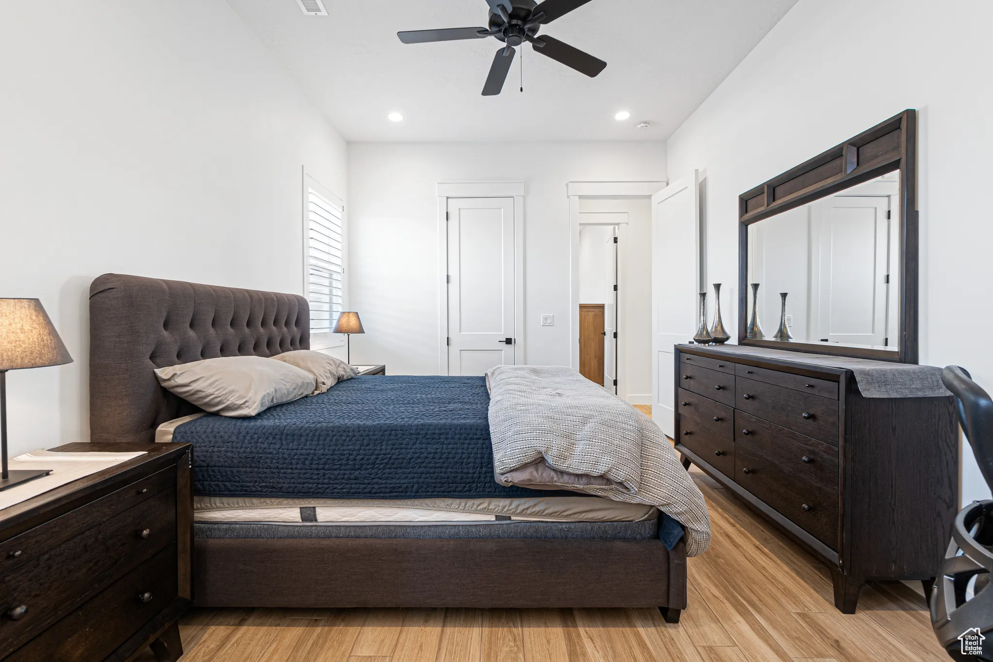 Bedroom with light wood finished floors, recessed lighting, and a ceiling fan