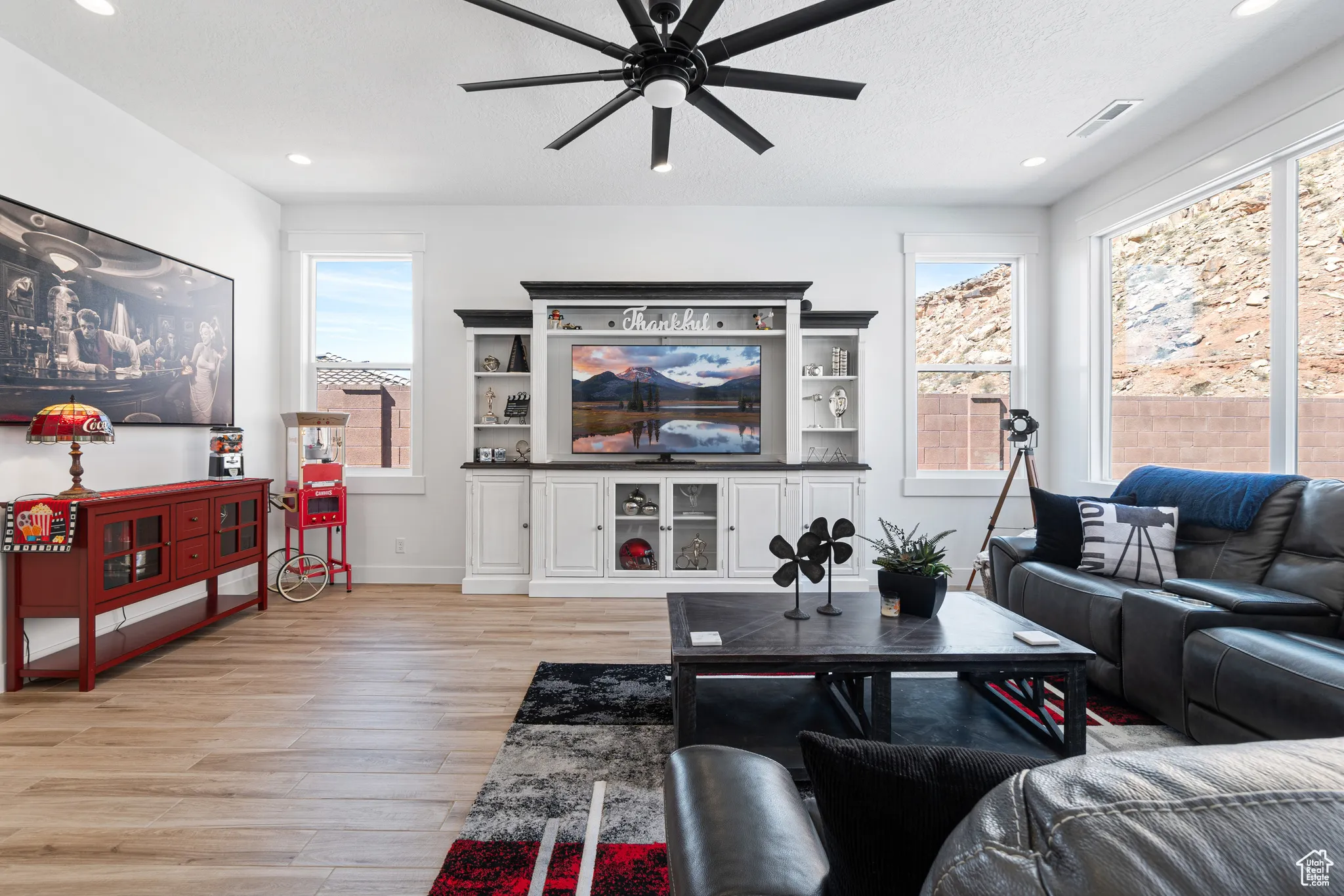 Living room featuring a ceiling fan, healthy amount of natural light, light wood-type flooring, and recessed lighting