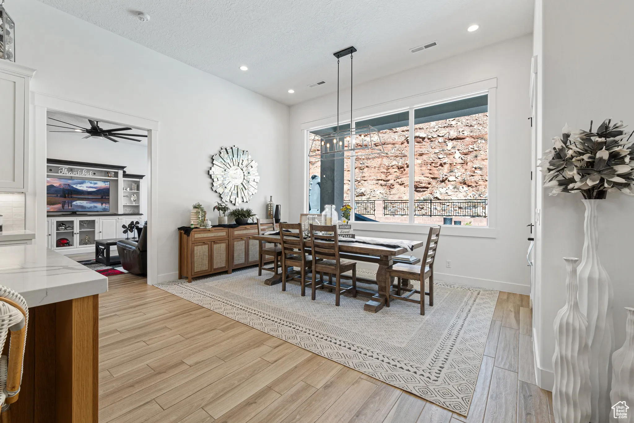 Dining space with light wood-style flooring, recessed lighting, a ceiling fan, and a textured ceiling