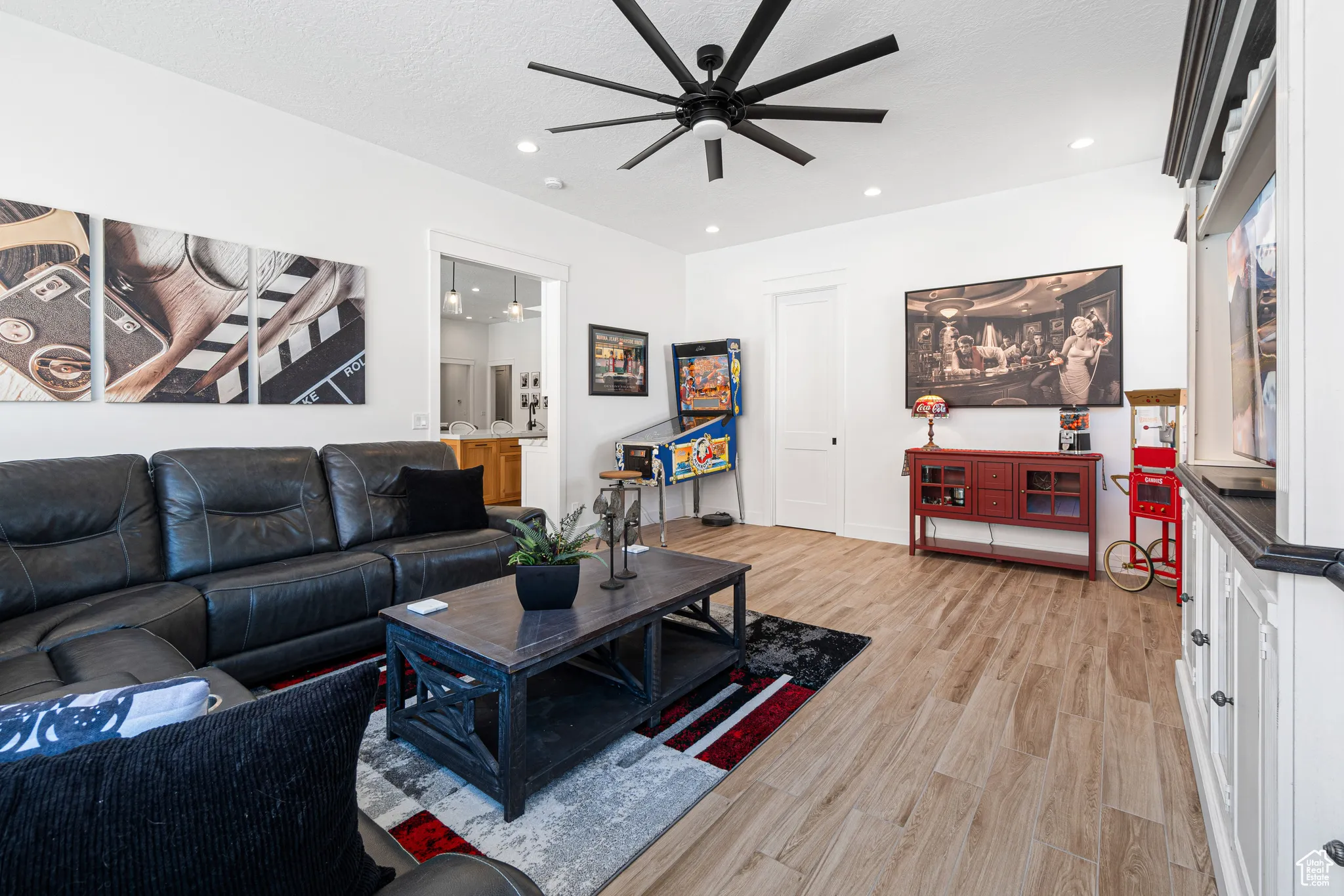 Living area featuring ceiling fan, light wood-style flooring, and recessed lighting
