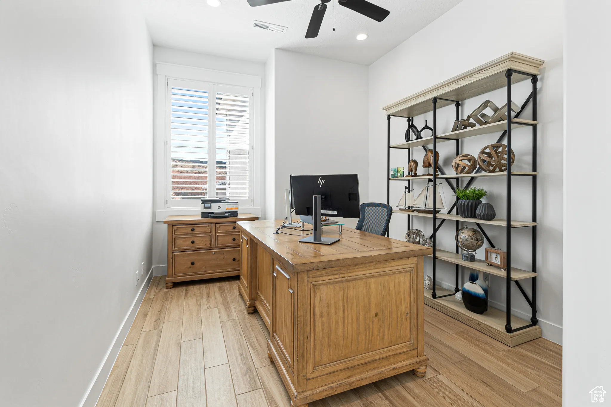 Office area with a ceiling fan, light wood finished floors, and recessed lighting