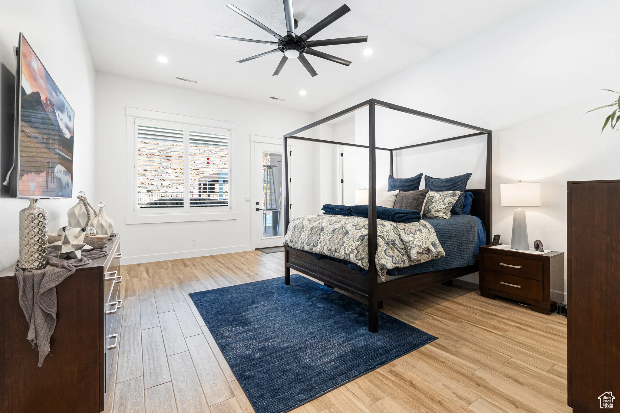 Bedroom with light wood-style floors, ceiling fan, access to exterior, and recessed lighting