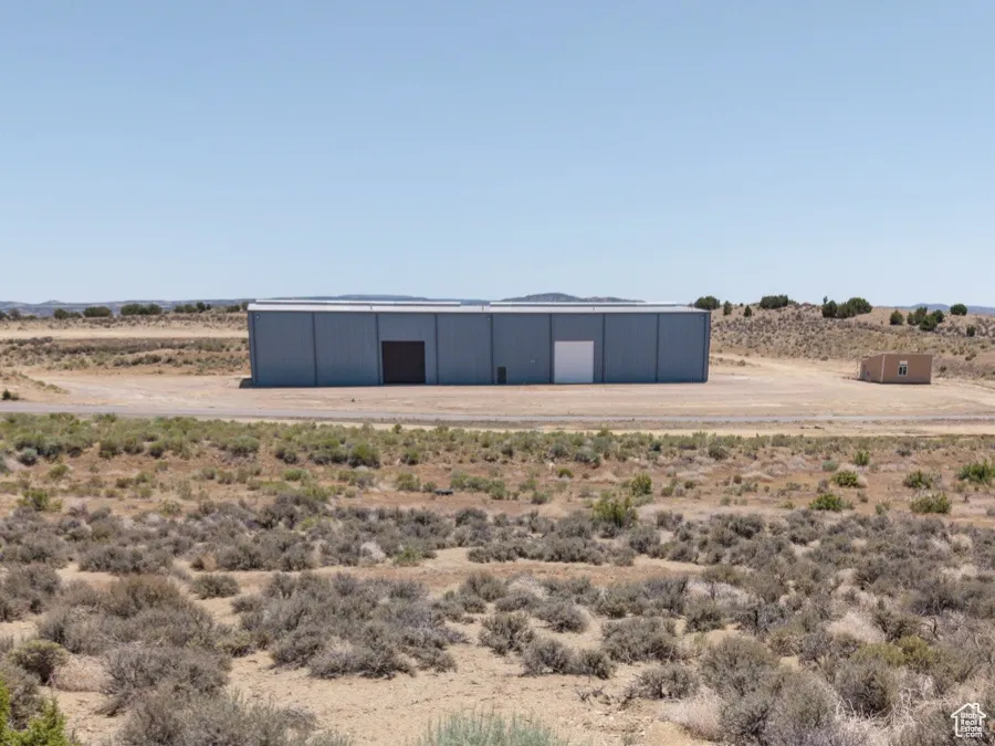 Exterior space with a pole building, a view of countryside, and an outdoor structure