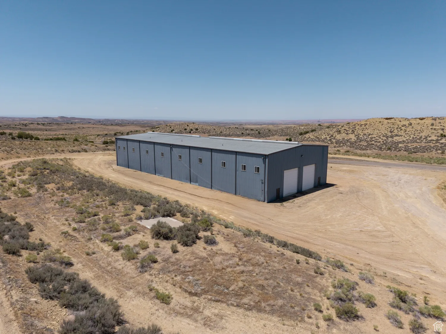View of outbuilding featuring view of desert and a view of rural / pastoral area