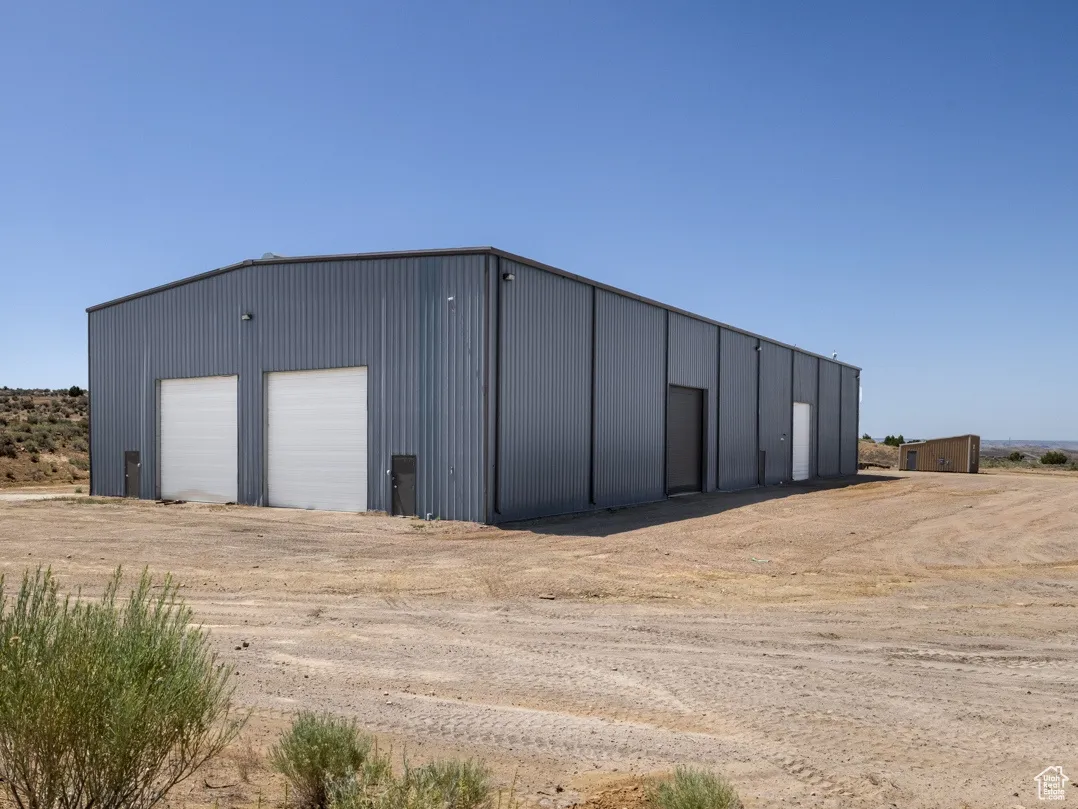 View of outbuilding featuring driveway