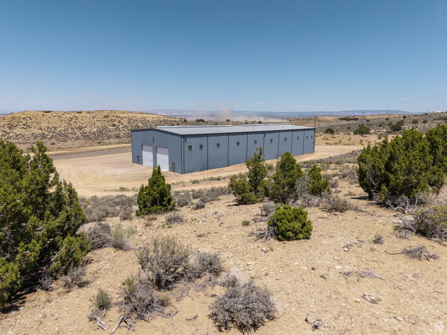 Water view with a pole building and rural landscape