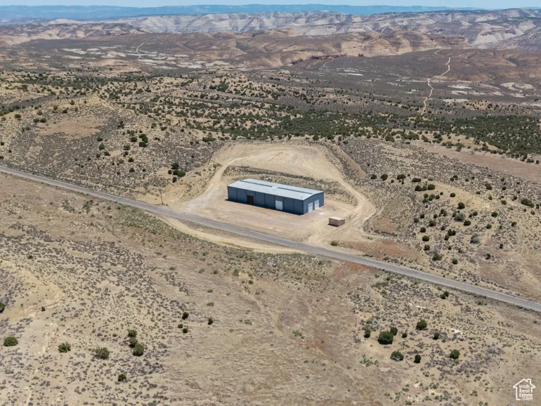 View of rural area with a desert landscape and a mountainous background